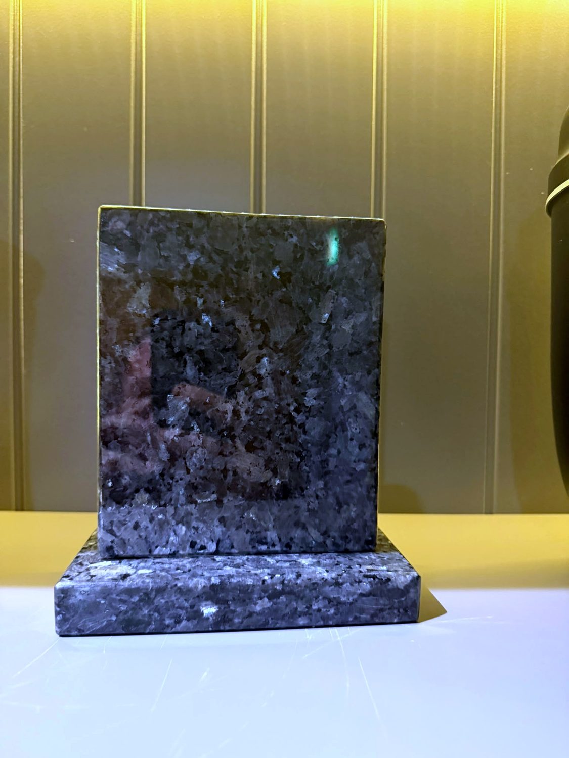 A polished blue-pearl granite sample showing its blue shimmer.